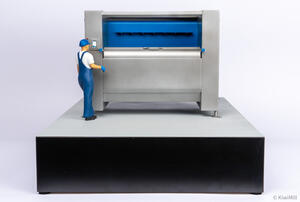 Belt chiller scale model front view with blue flighted belt, operator figure at touchscreen, and black display base